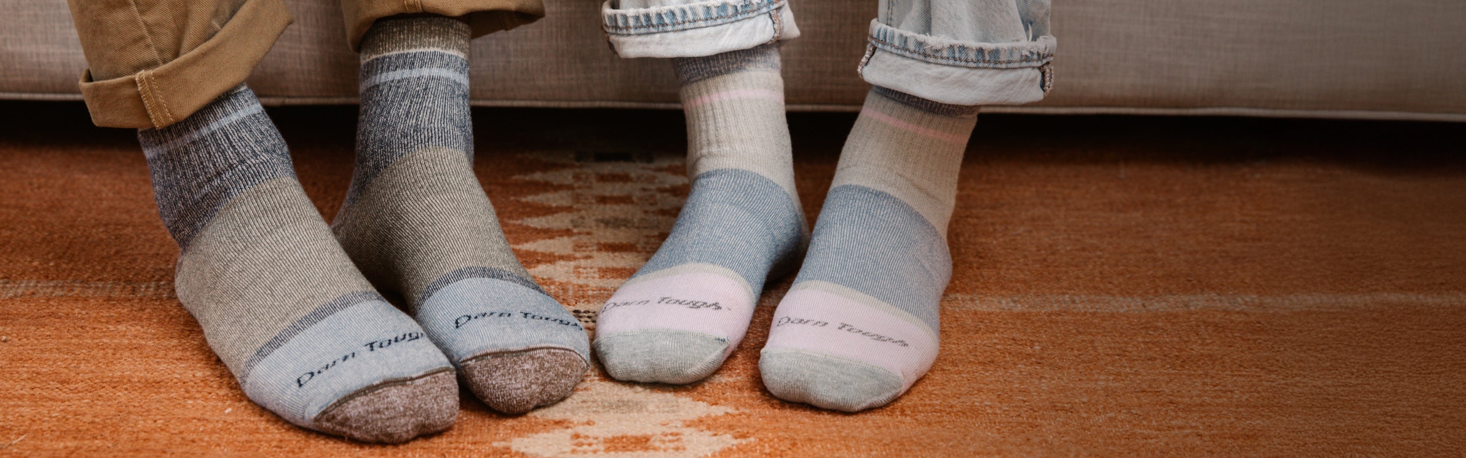 Feet wearing matching cozy couples socks for Valentine's Day
