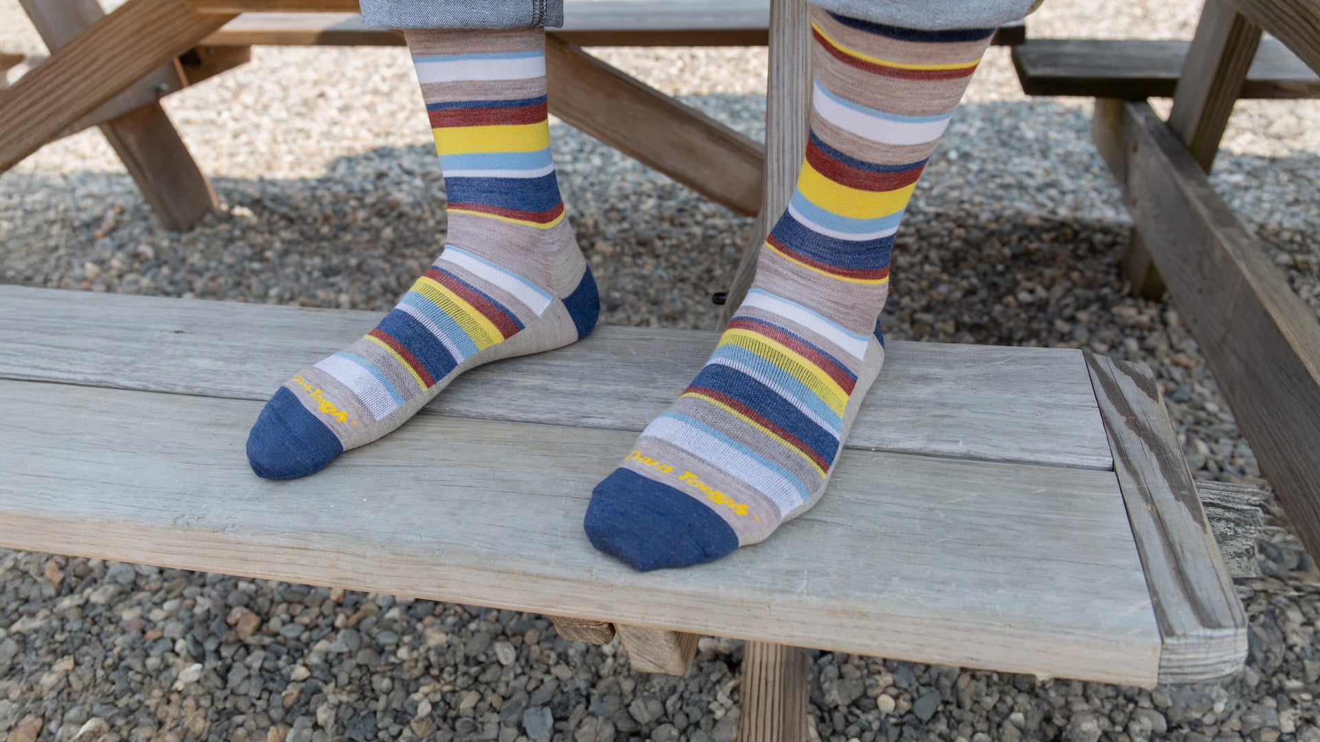 models feet up on a bench seat wearing the druid crew sock in rye