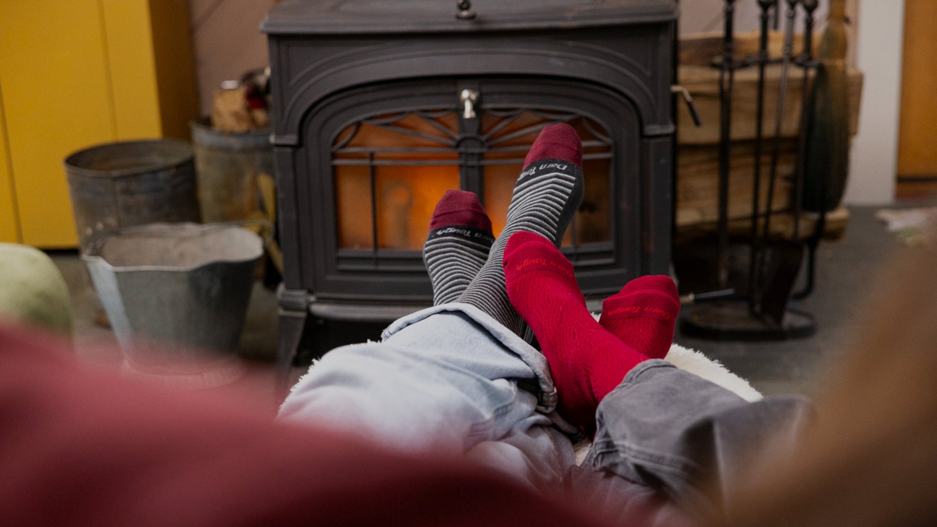 Models feet infront of a fire place wearing new lifestyle socks