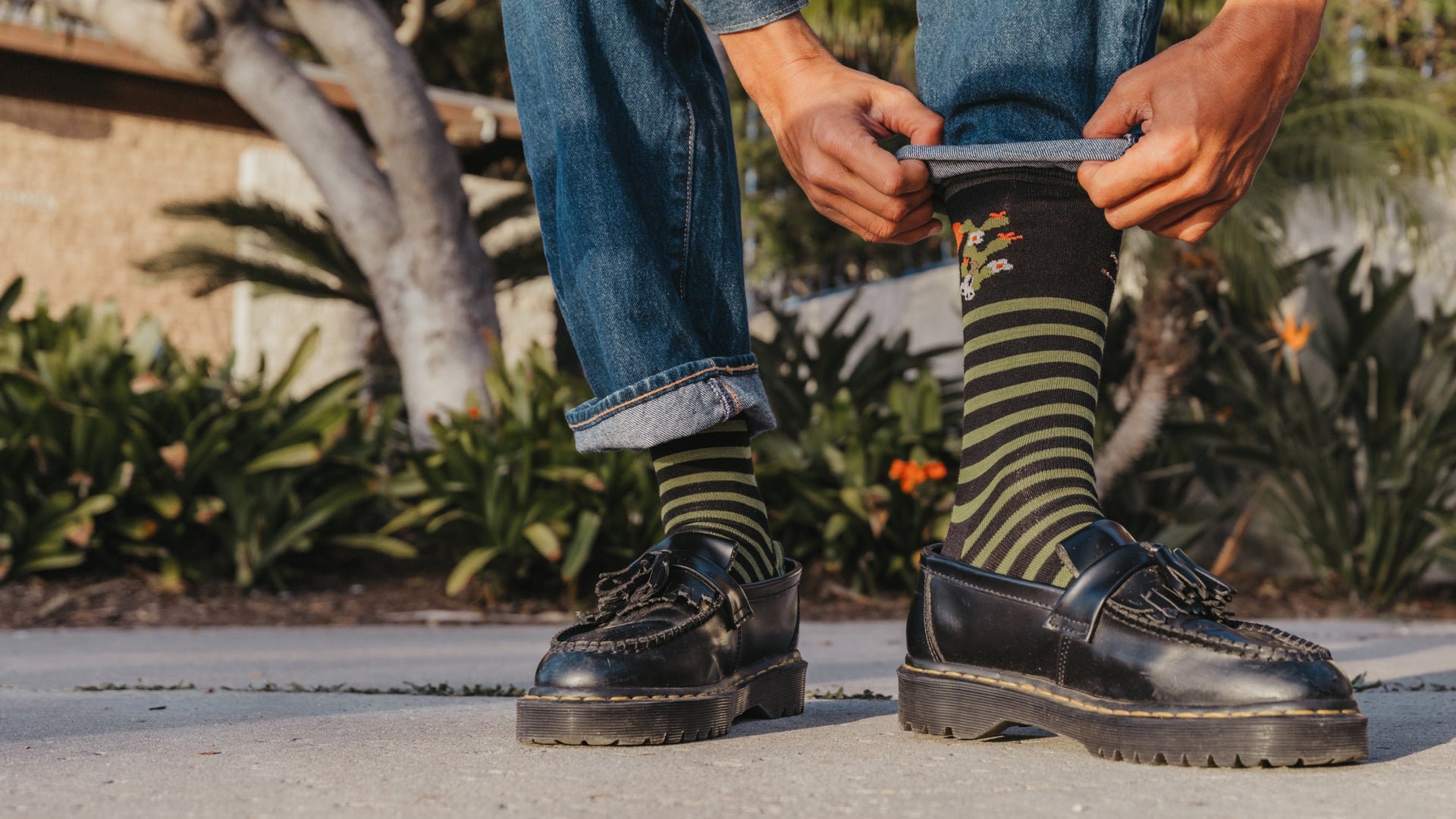 Model holding pant leg showing the animal haus in gator green