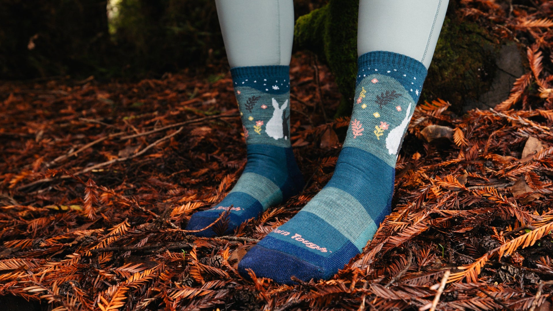 Model with feet in leaves wearing the critter club eclipse 