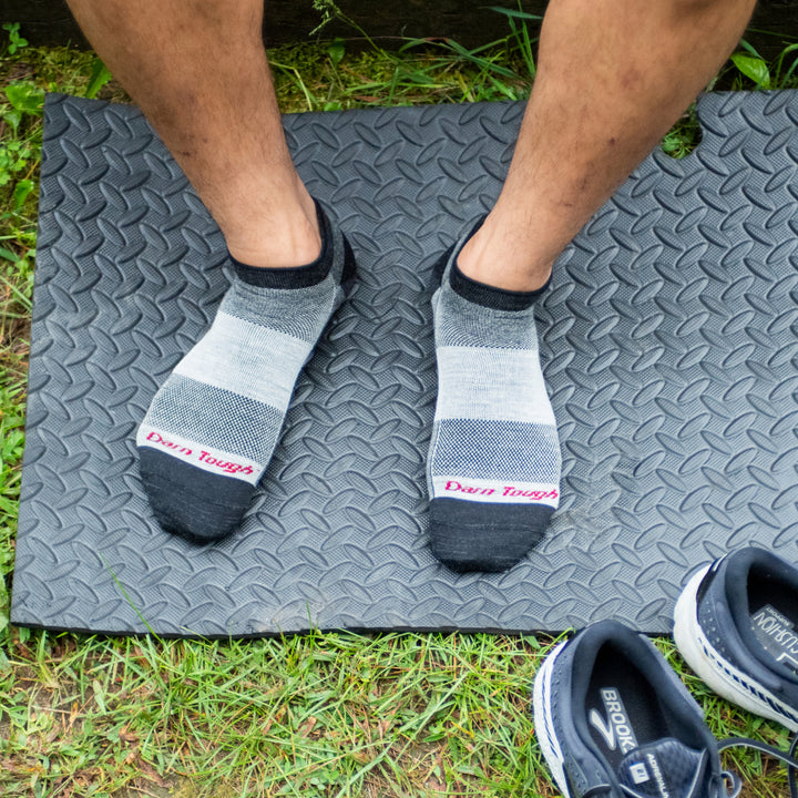 Athlete standing on yoga matt wearing 1437 no show athletic socks