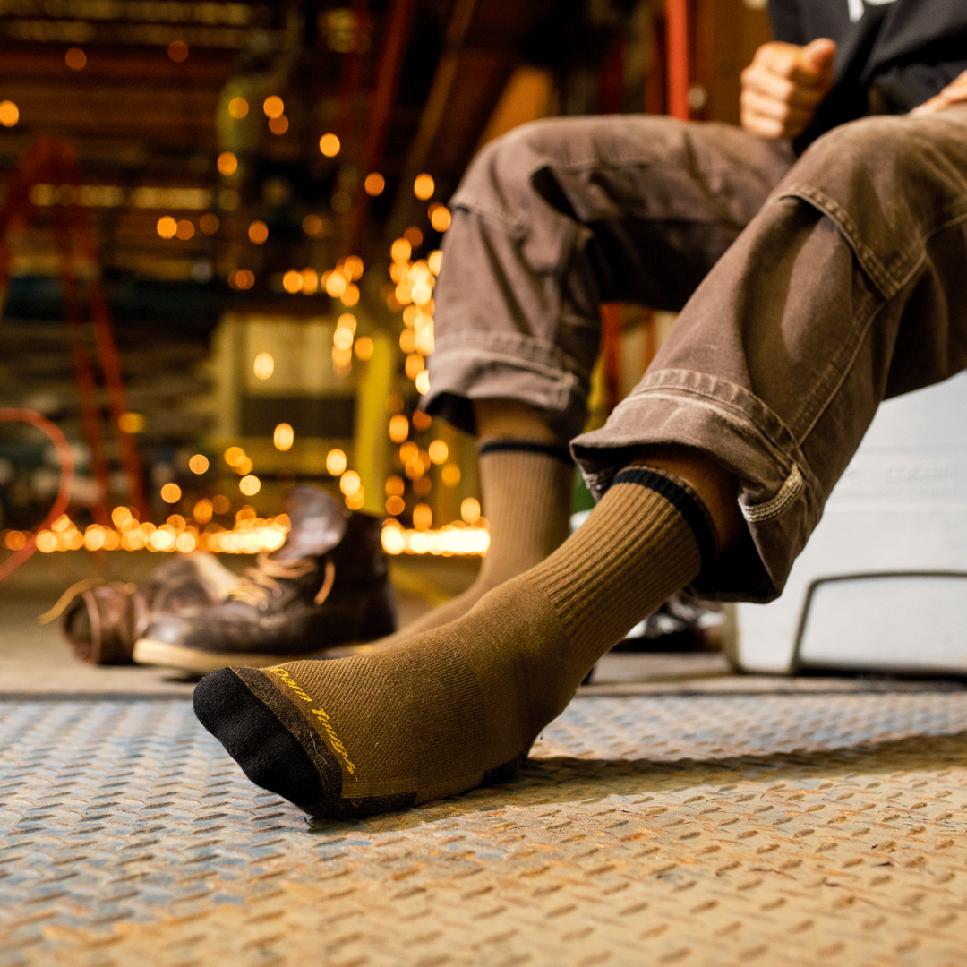 Closeup of Fred Tuttle socks in timber brown on worker's feet