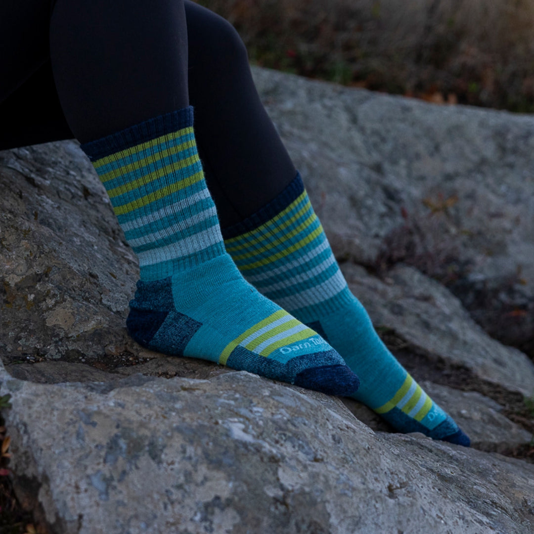 close up of models feet on rocks wearing 1946 boot midweight with full cushion sock aqua