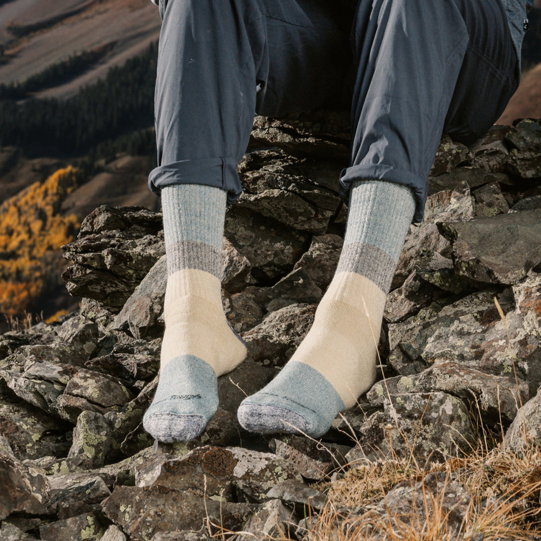 models feet on rocks wearing the 1953 Micro crew Mountaineering sock in Geyser colorway