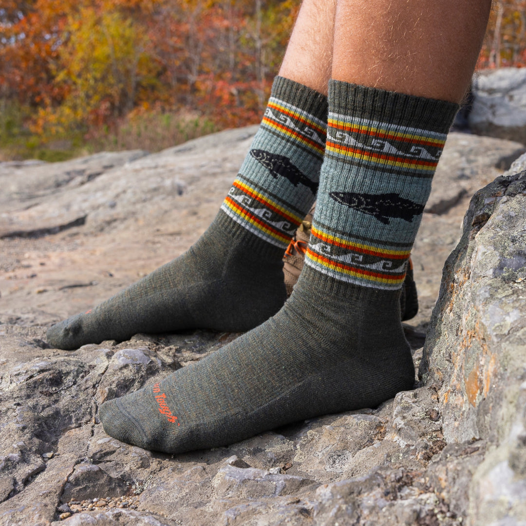 close up of models feet on rocks wearing 1980 boot midweight with cushion trout river socks