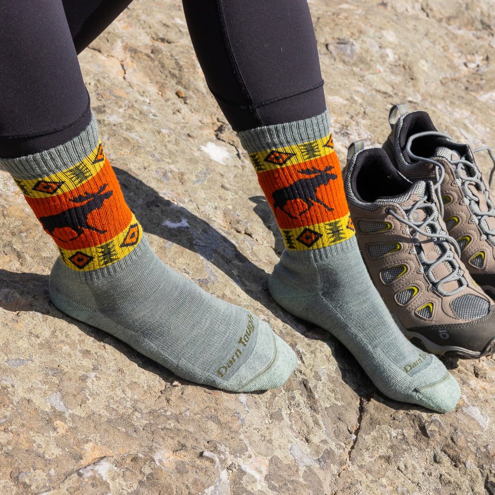 close up of models feet on rocks wearing 5017 moose meadow vanna grizzle boot midweight with cushion