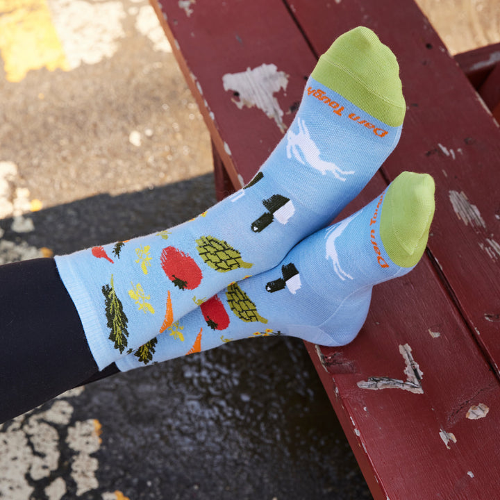 up close on model image of the 6054 Sky featuring light green toe blue body and veggies on ankle
