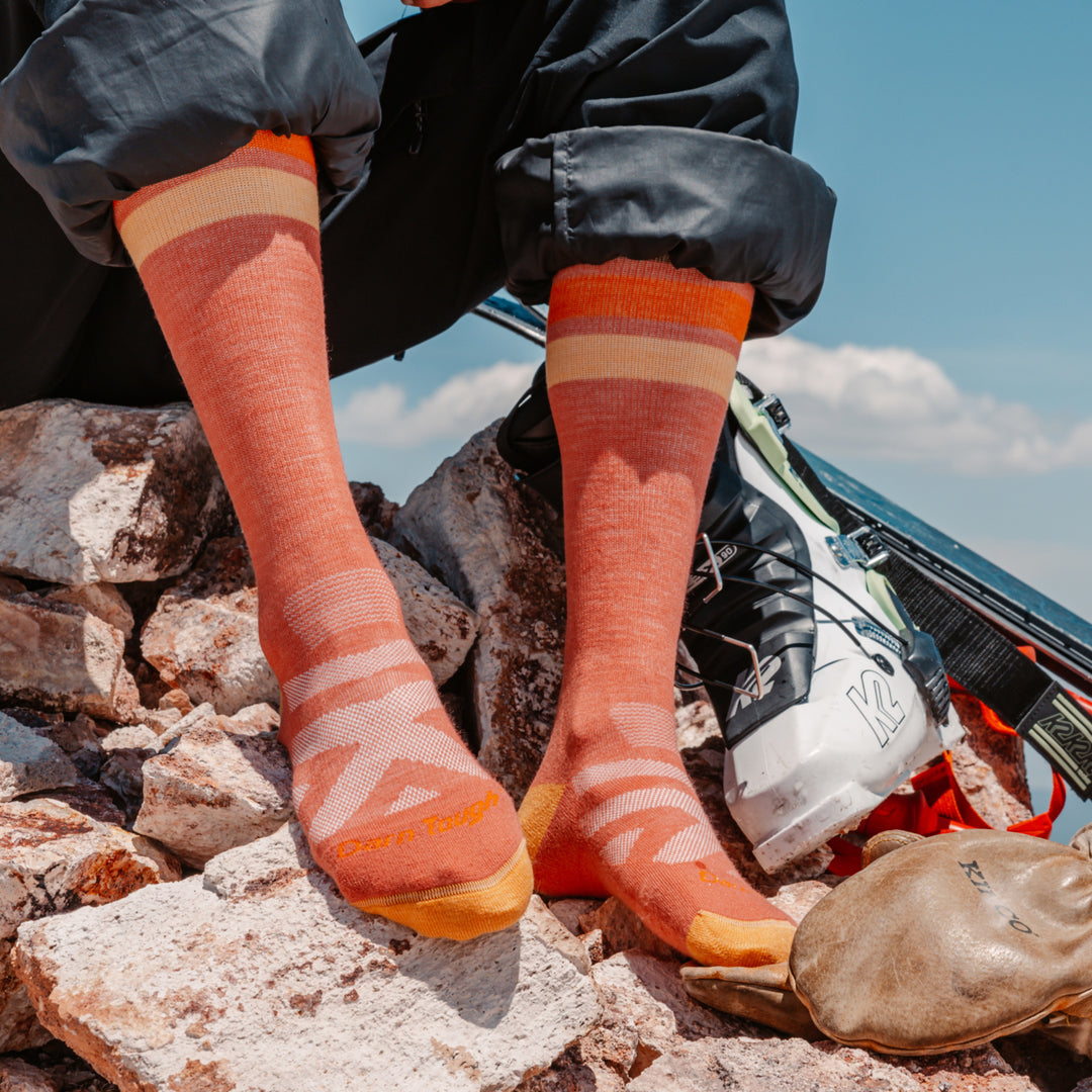close up on model image of the 8028 canyon resting on rocks next to ski boots and skis