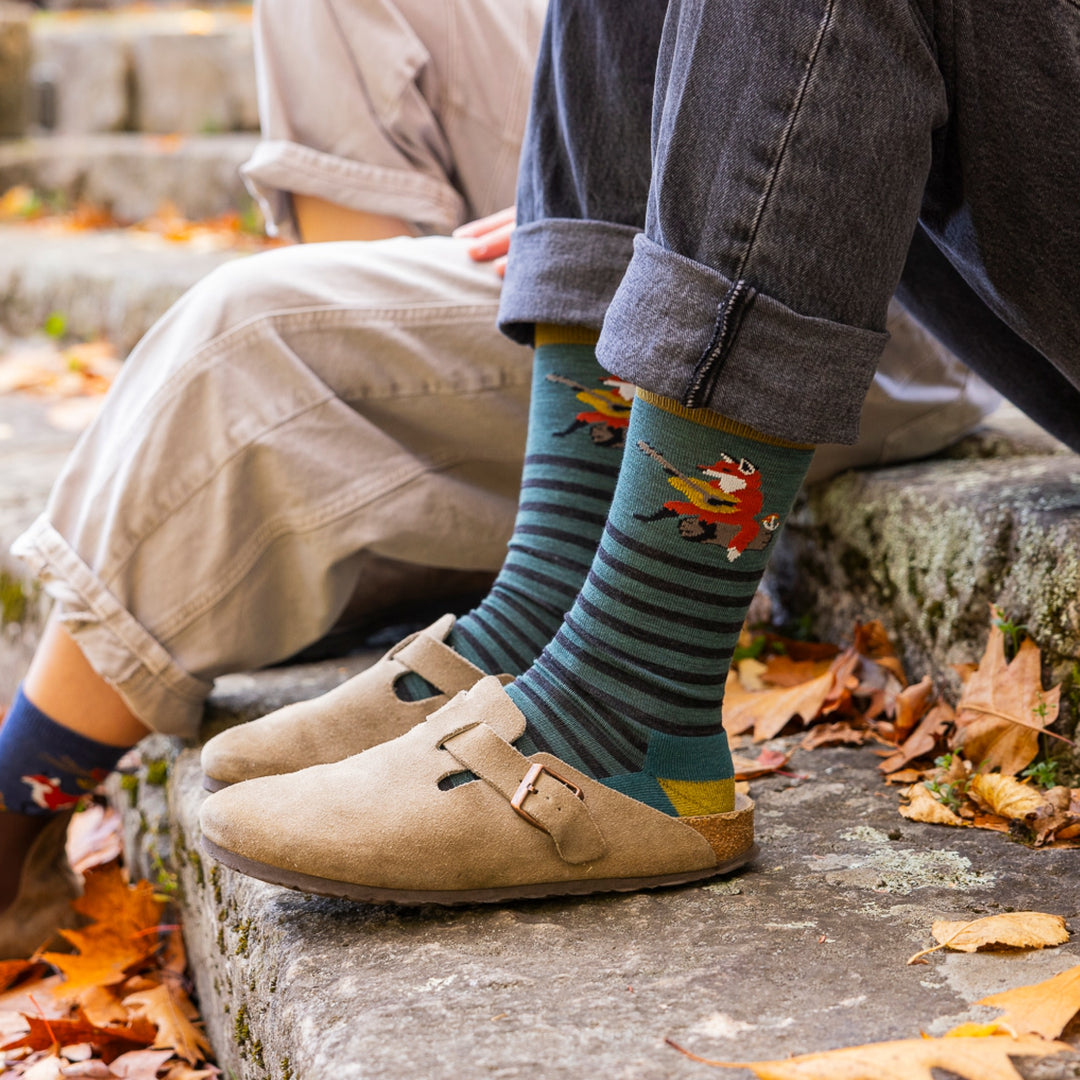 close of image of womans feet in clogs with cuffed jeans wearing 6096 wildlife crew lightweight with cushion fox teal socks