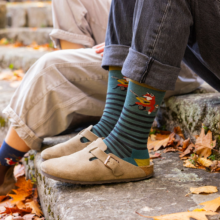 close of image of womans feet in clogs with cuffed jeans wearing 6096 wildlife crew lightweight with cushion fox teal socks