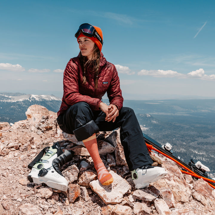 Model sitting atop mountain wearing the 8028 Canyon