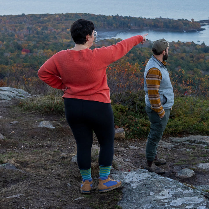 woman pointing into distance while hiking with man wearing 1946 boot midweight with full cushion aqua sock