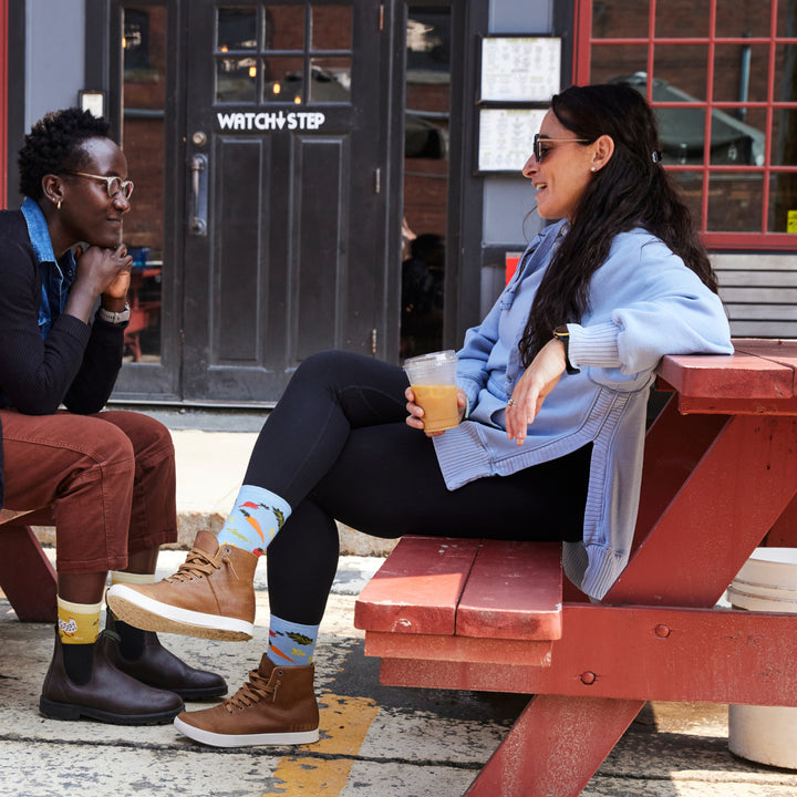 models sitting on picnic table wearing the 6054 Sky in low boots