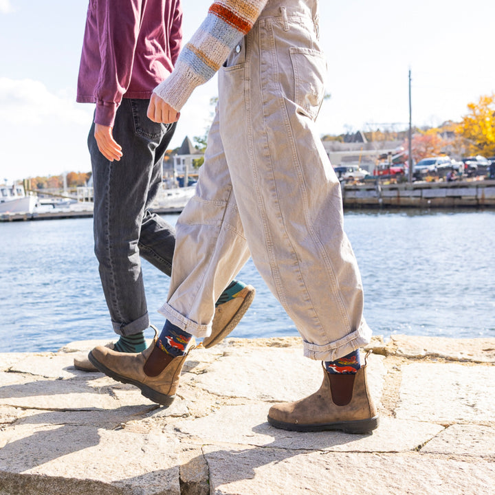 image of man and woman walking on stone near the water woman wearing boots with 6105 wildlife crew lightweight with cushion fox foliage sock