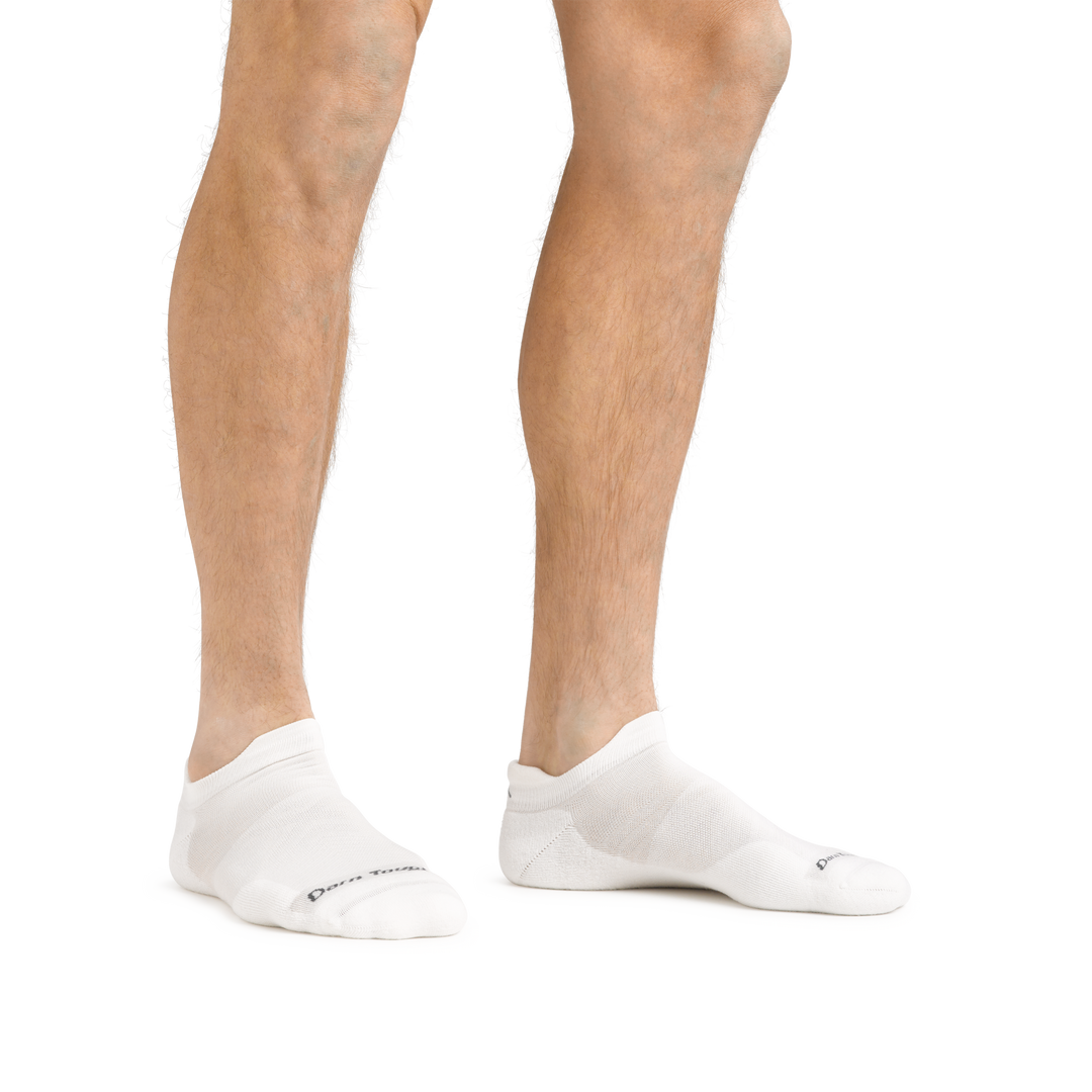 Man standing barefoot wearing Run No Show Tab Ultralightweight Running Socks in White
