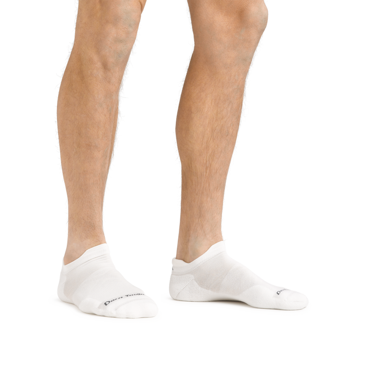 Man standing barefoot wearing Run No Show Tab Ultralightweight Running Socks in White