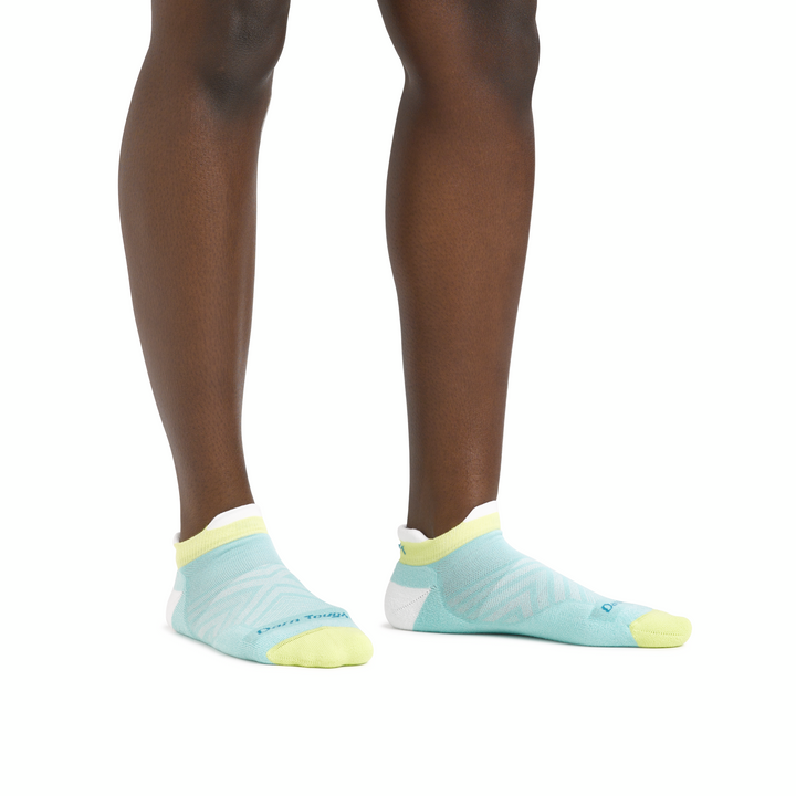 Close up studio shot of model wearing Coolmax no show socks in aqua.