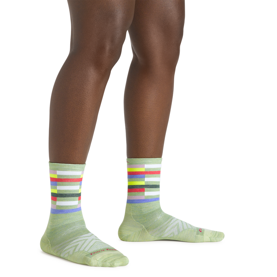 Close up shot of model wearing the women's relay micro crew running sock in mint with no shoes on