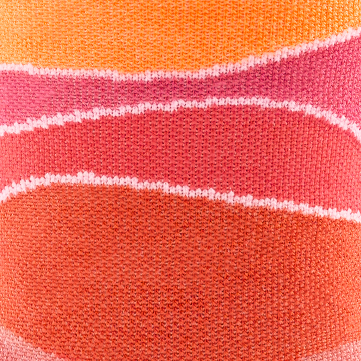 Call out detail image of the of the 1064 Canyon front side image of orange pink and peach wave lines