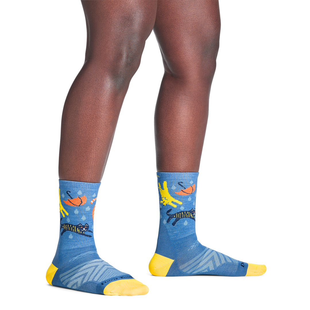 model standing barefoot wearing the 1070 ruff weather micro crew running sock in storm blue colorway