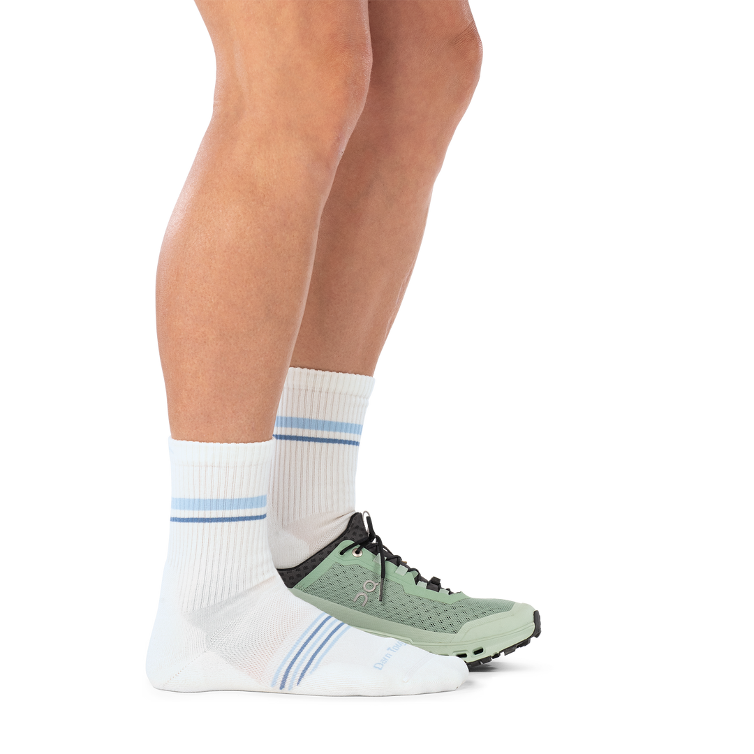model wearing shoe on back foot and 1114 vapor white micro crew light weight with cushion sock side profile