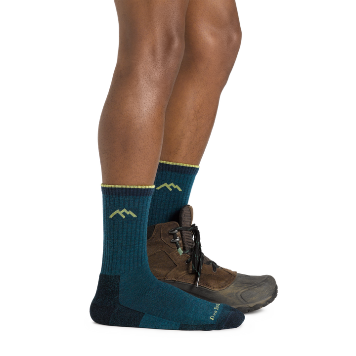 Profile of male legs facing to the right, front foot wearing Hiker Micro Crew Midweight Hiking Sock in Dark Teal, foot in back also wearing a hiking shoe