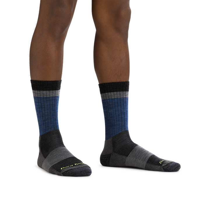 Man barefoot, wearing Heady Stripe Micro Crew Hiking socks in Blue