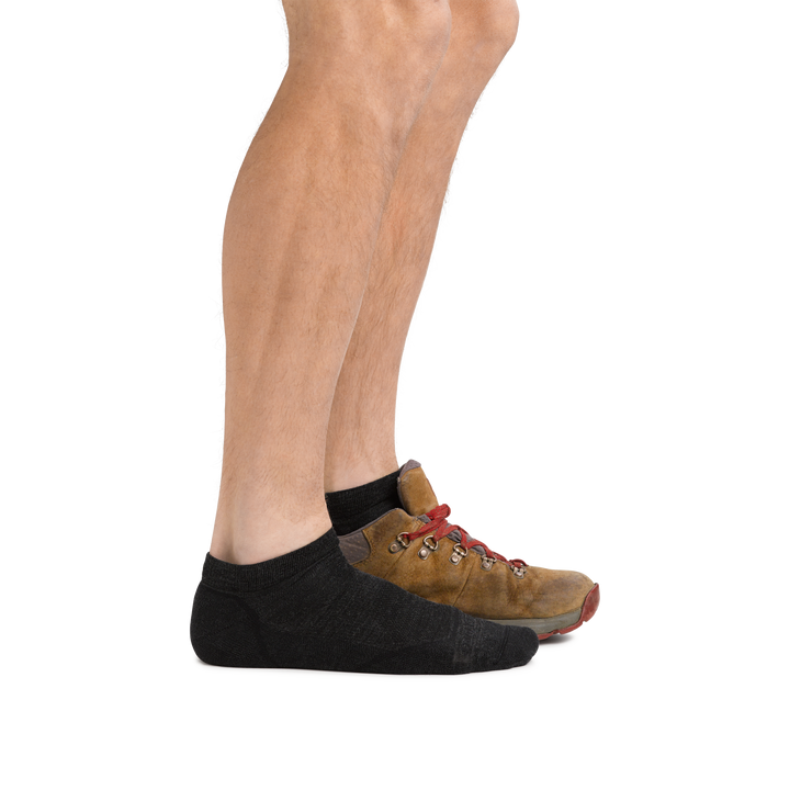Man wearing Light Hiker No Show Lightweight Hiking Socks in Black and back foot also in a hiking boot