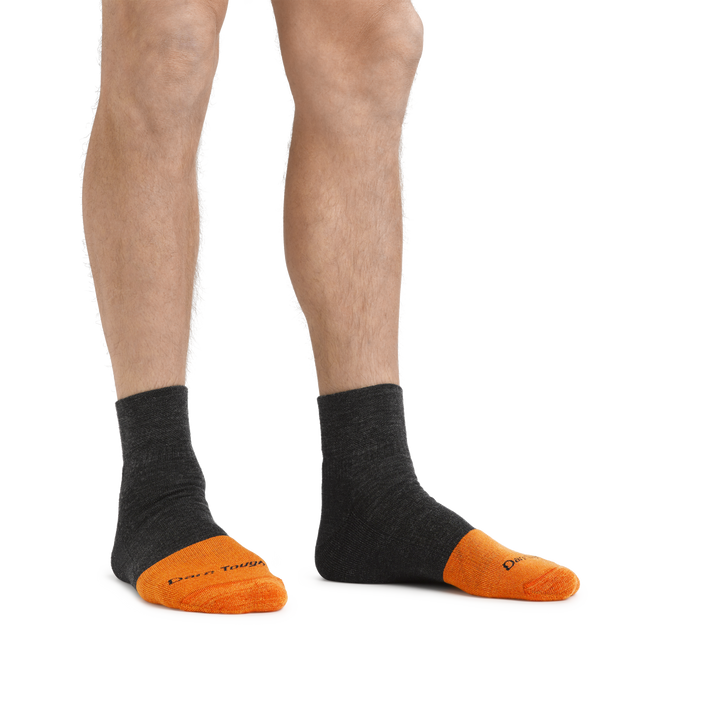 Man standing barefoot wearing Steely Quarter Midweight Work socks in Graphite