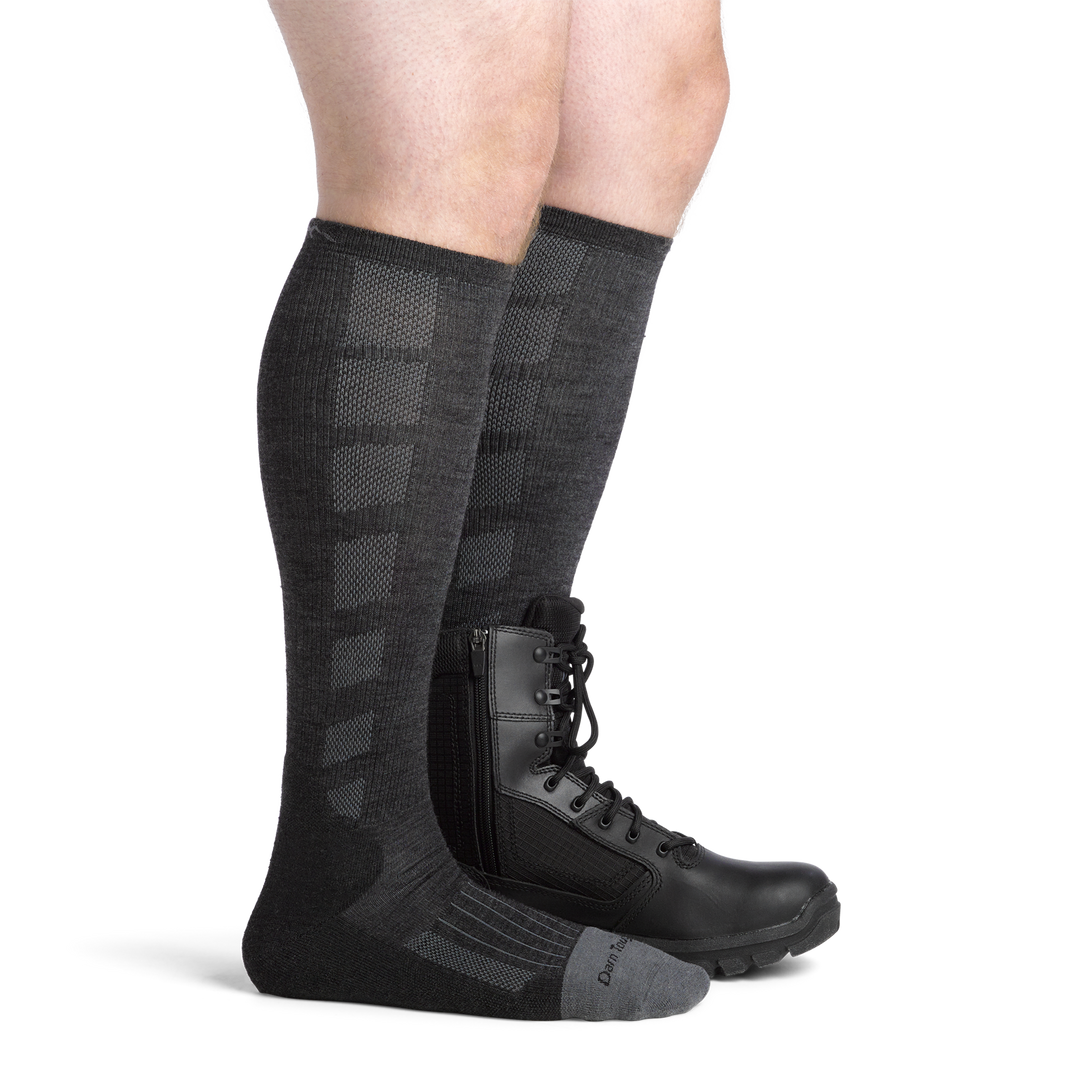 Model wearing the men's Stanly K OTC work socks in Gravel with a black boot on his left foot