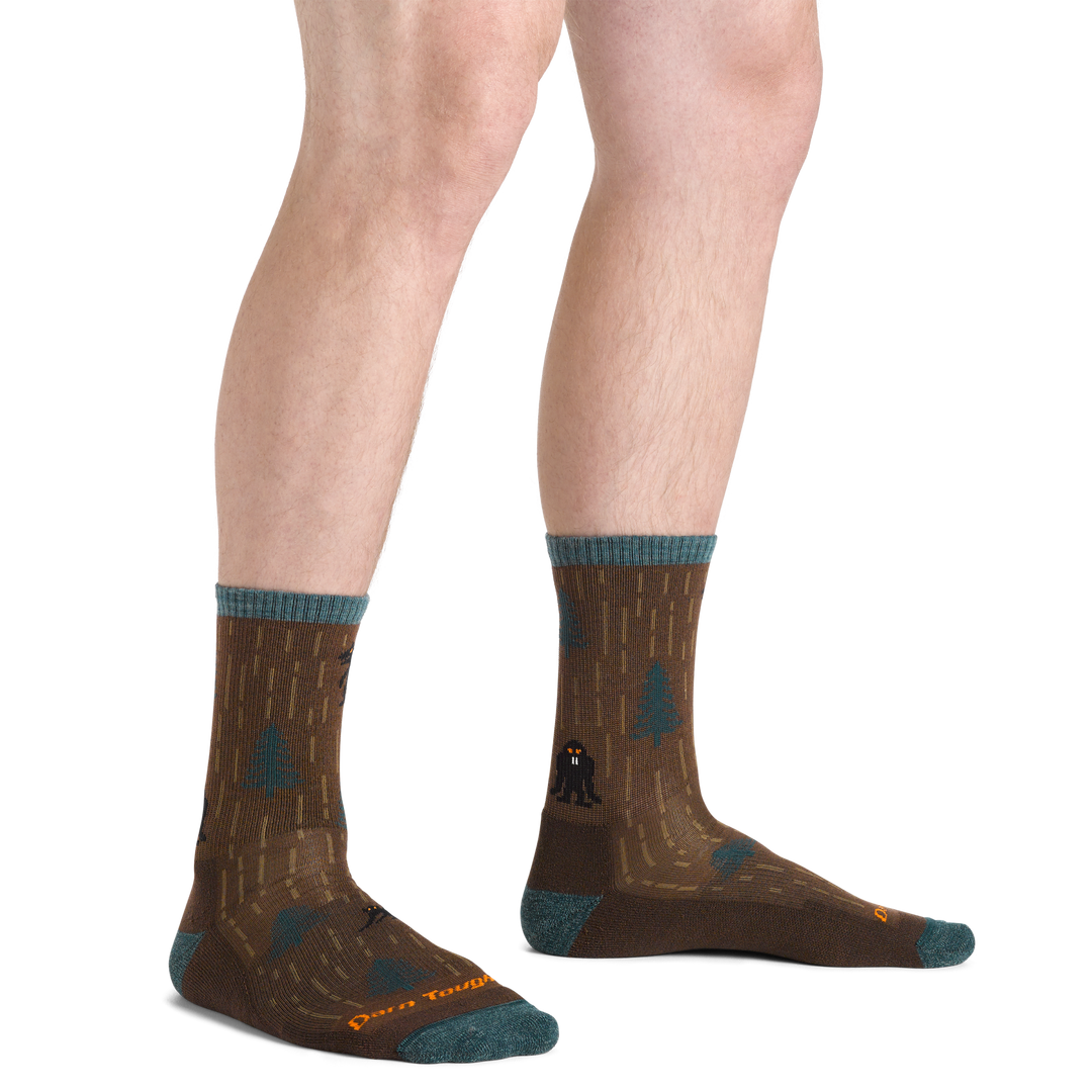 Close up shot of model wearing the men's yarn goblin micro crew hiking sock in earth colorway with no shoes on