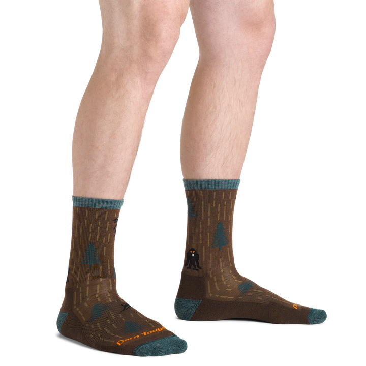 Close up shot of model wearing the men's yarn goblin micro crew hiking sock in earth colorway with no shoes on
