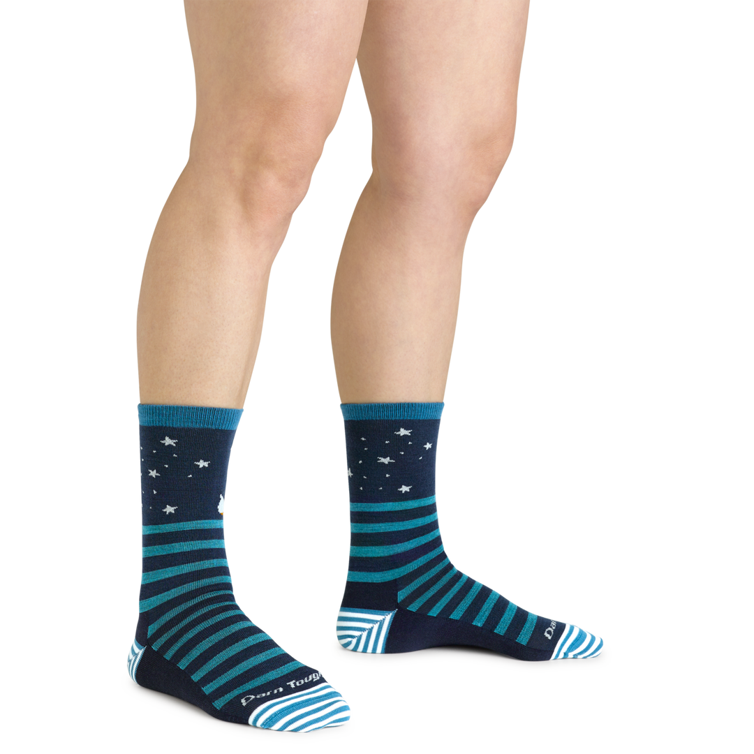 Close up shot of model wearing the women's animal haus crew lifestyle sock in eclipse with no shoes on