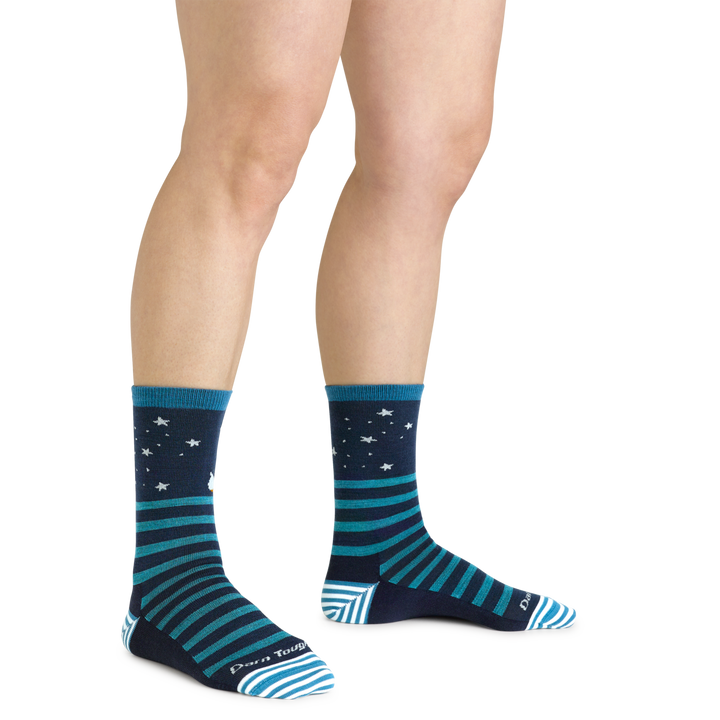 Close up shot of model wearing the women's animal haus crew lifestyle sock in eclipse with no shoes on