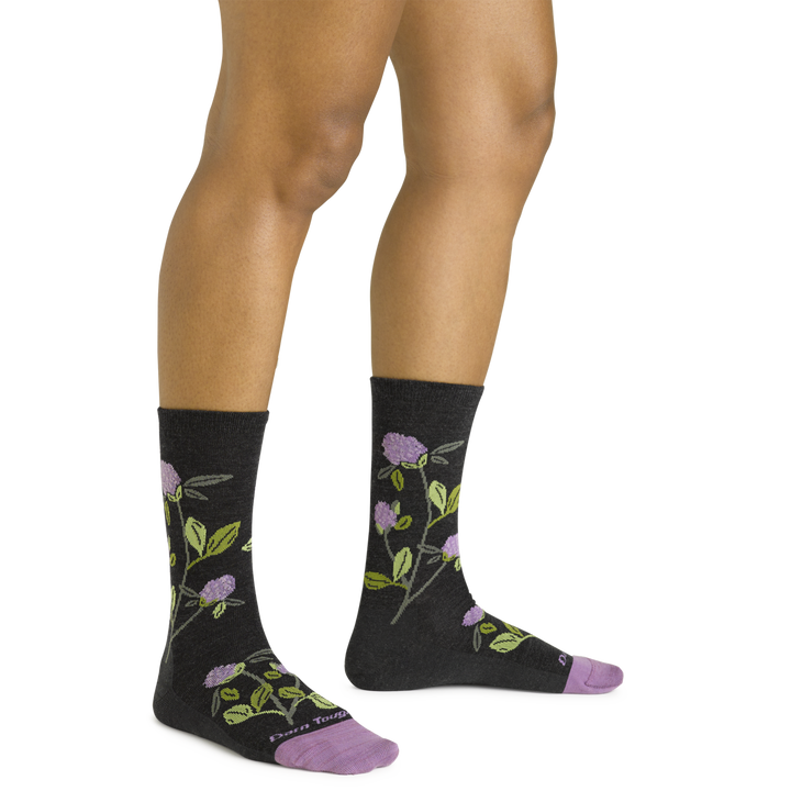 Close up shot of model wearing the women's blossom crew lifestyle socks in charcoal with no shoes on