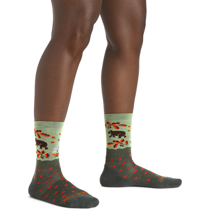 Close up shot of model wearing the women's wild life crew lifestyle socks in Forest with no shoes on