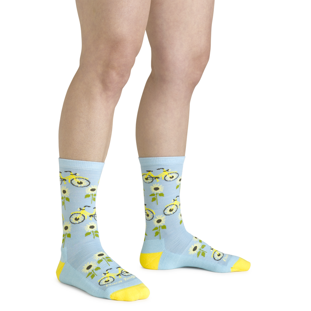 Close up shot of model wearing the women's sun pedal crew lifestyle sock iin glacier blue with no shoes on