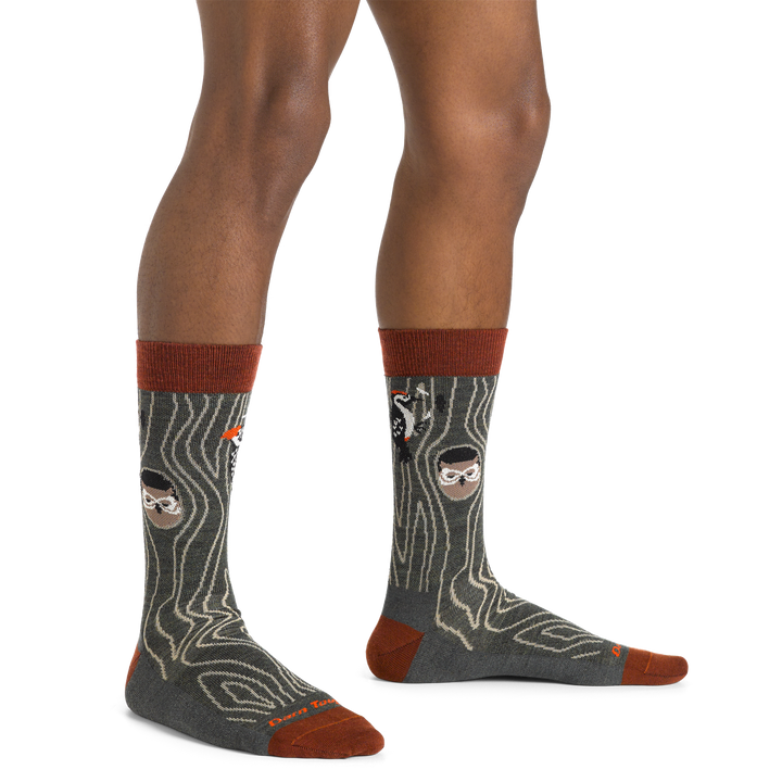 Side studio shot of model wearing men's woody crew lifestyle sock in forest