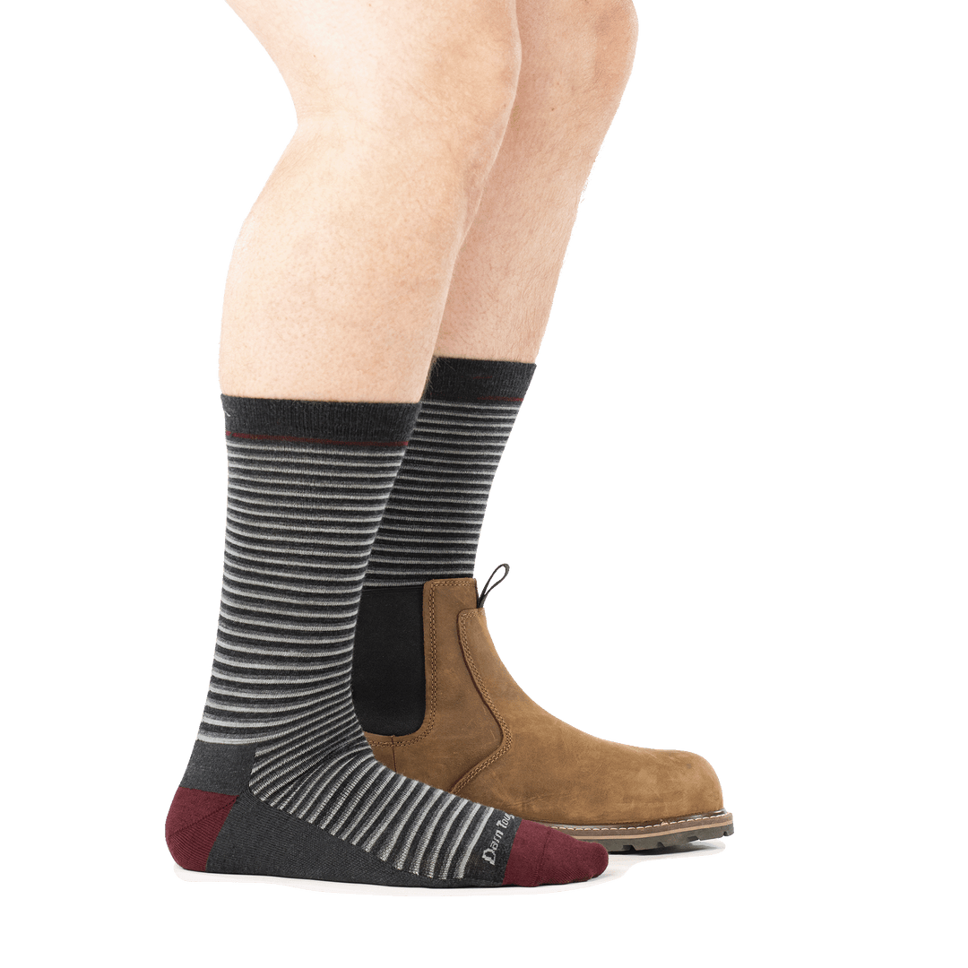 model wearing boot on back foot and 6134 charcoal crew lifestyle sock side profile