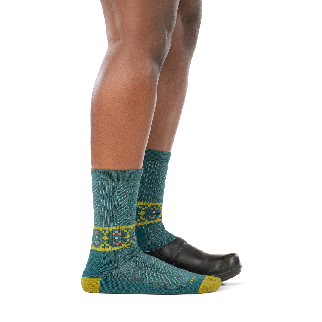 model wearing clog on back foot and 6141 teal lightweight crew with cushion sock on front foot side profile