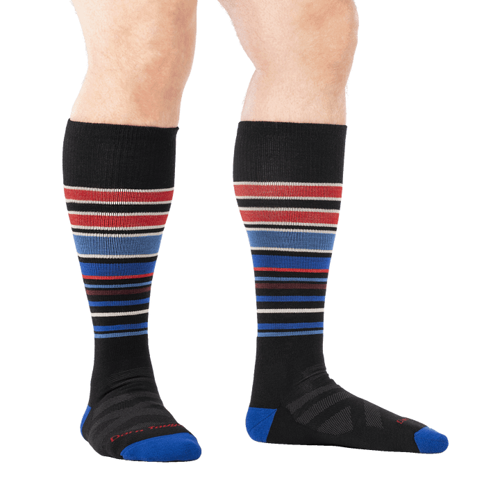 on model image of man barefoot in a staggered stance wearing 8017 black midweight OTC ski and snowboard sock
