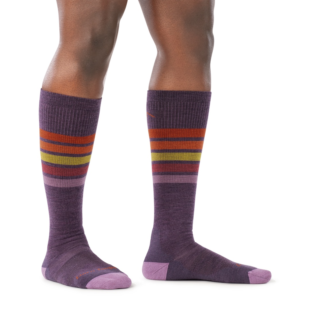 on model image of woman staggered stance barefoot wearing 8028 OTC ski and snowboard midweight sock in plum