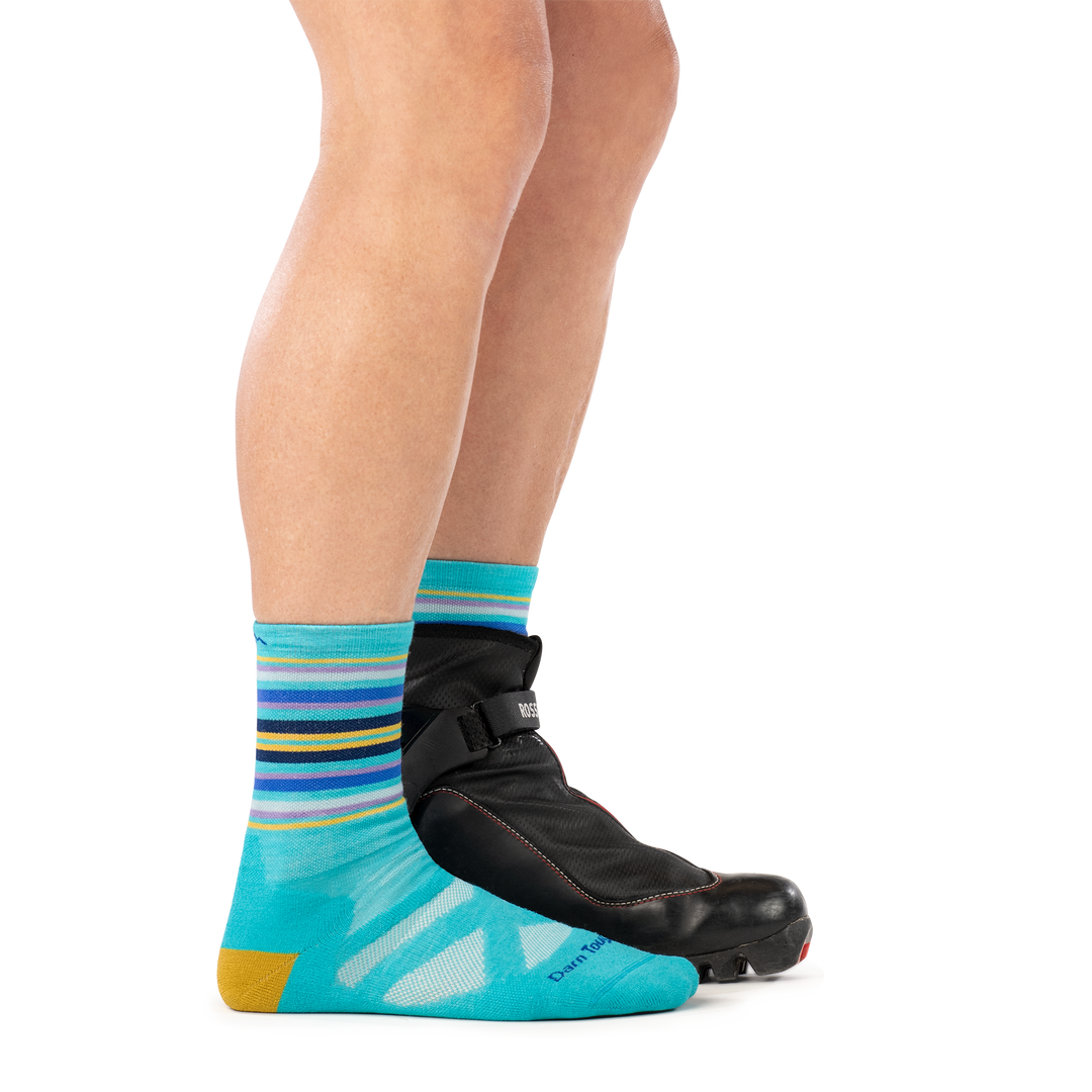 model wearing nordic boot on back foot and 8033 nordic boot sock in teal side profile