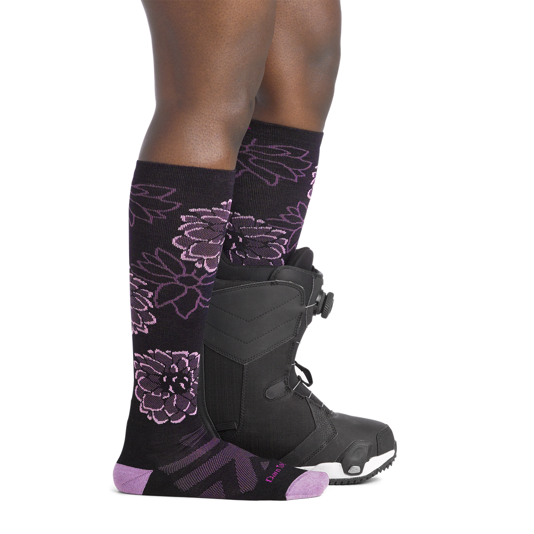 on model image side view back foot in boot wearing the 8056 dahlia over the calf sock in black colorway 