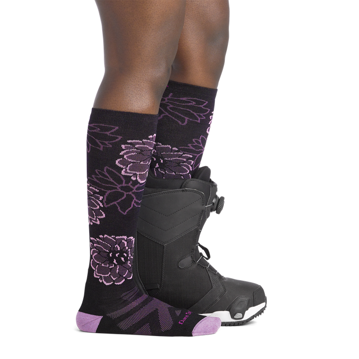 on model image side view back foot in boot wearing the 8056 dahlia over the calf sock in black colorway 