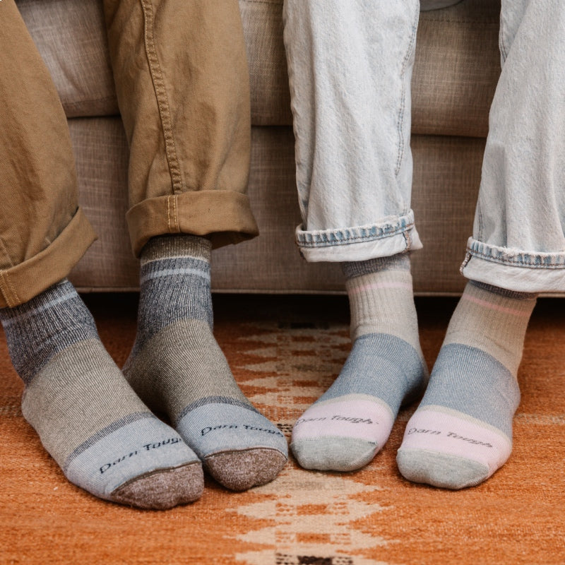 Feet wearing matching cozy couples socks for Valentine's Day