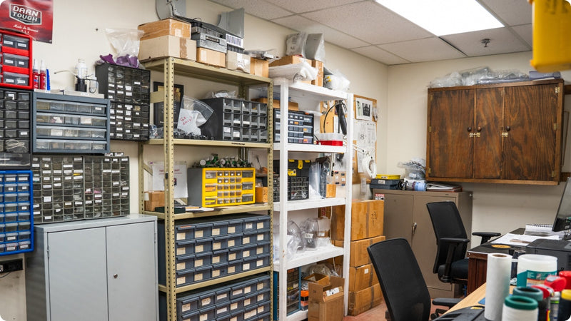 A peak inside an office full of file cabinets, drawers, and tools