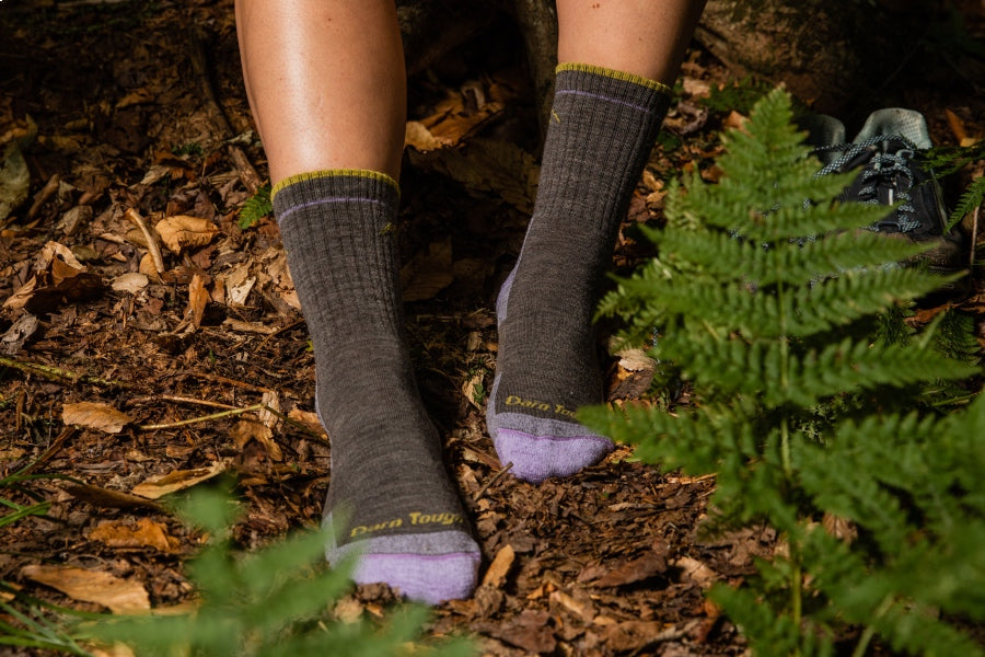 Feet wearing the women's hiker micro crew socks in taupe brown with lavender heel and toes