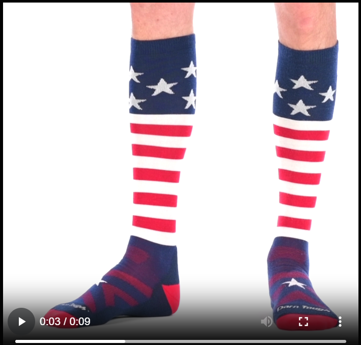 Video of model wearing captain stripe over the calf snow socks, walking around to show all angles of the socks.